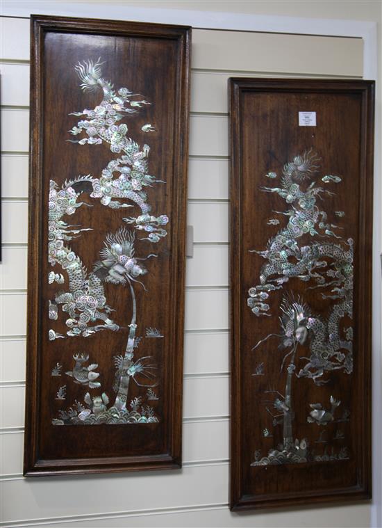 A pair of Chinese rosewood and mother of pearl inlaid dragon panels, late 19th century, 98 x 34cm, slight losses to one dragon